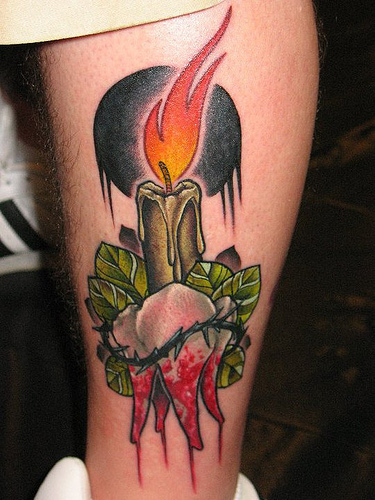 Burning Candle With Tooth Tattoo On Leg