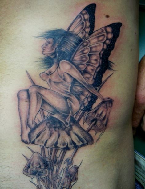 Grey Ink Fairy Sitting Mushroom Tattoo On Side