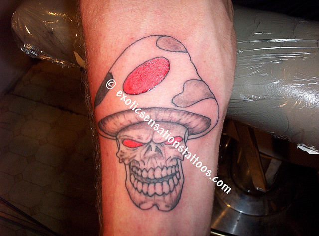 Red Eyes Evil Mushroom Tattoo On Forearm