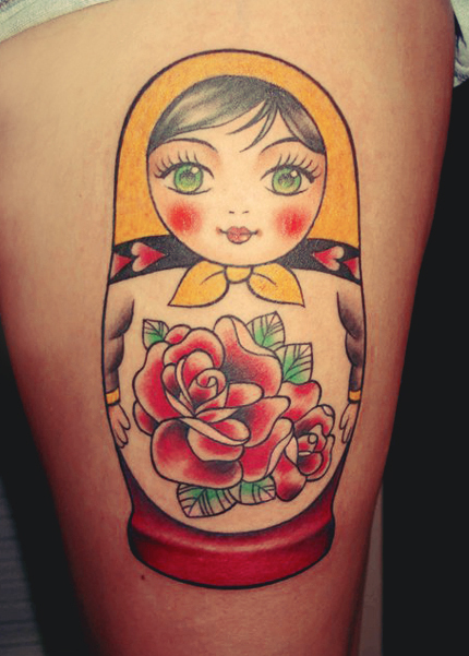 Red Rose Flower And Matryoshka Tattoo On Thigh