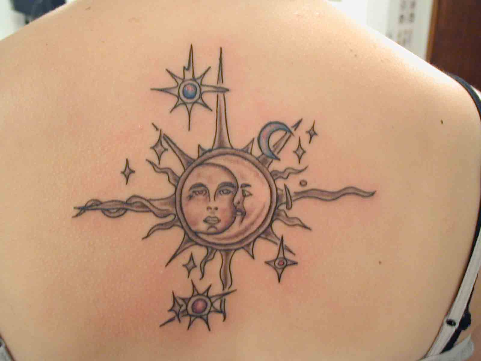 Sun With Half Moon And Stars Tattoo On Girl Upper Back