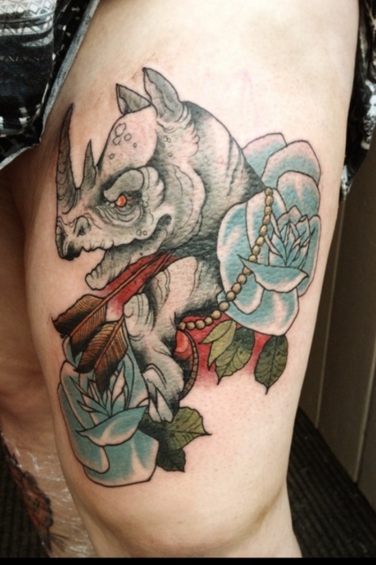 Two Arrow In Rhino Head With Roses Tattoo On Thigh