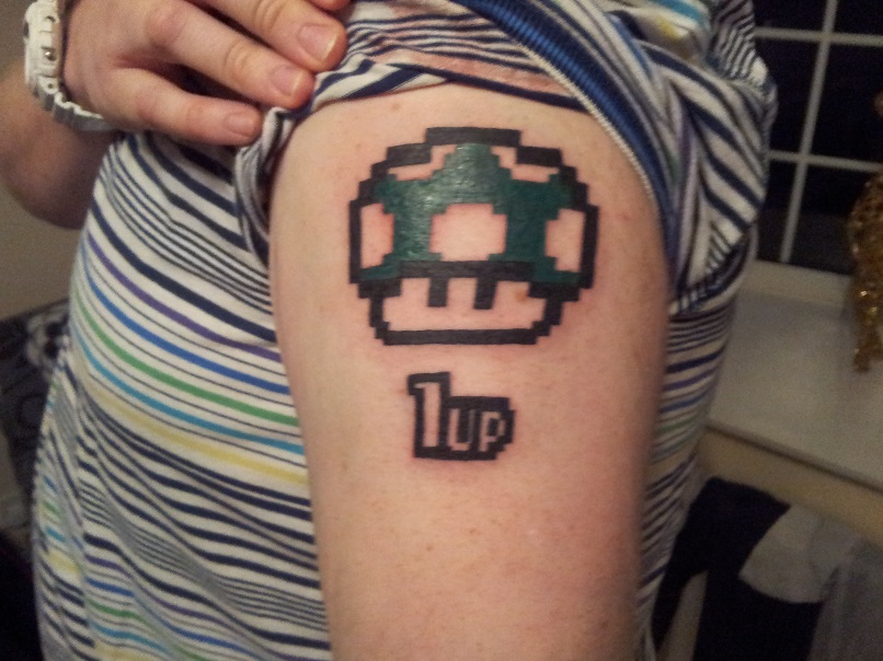 1 up Mario Mushroom Tattoo On Left Shoulder