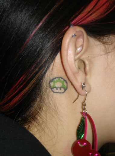Beautiful Green Mario Mushroom Tattoo Behind Ear