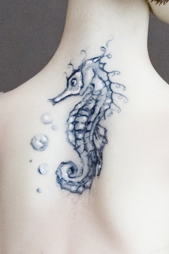 Black And Grey Seahorse Tattoo On Upper Back