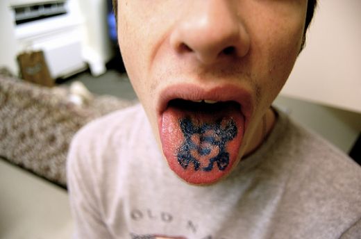 Black Dollar Sign Tattoo On Tongue