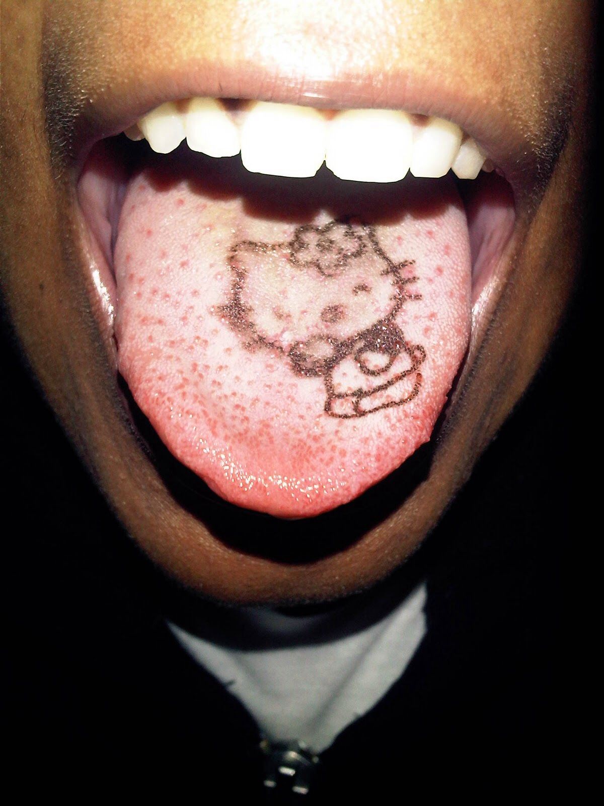 Black Hello Kitty Tattoo On Tongue