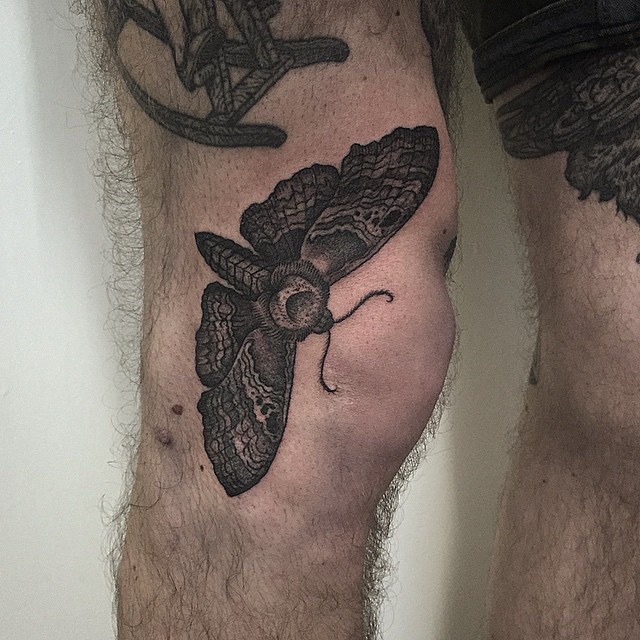 Black Ink Moth Tattoo On Knee