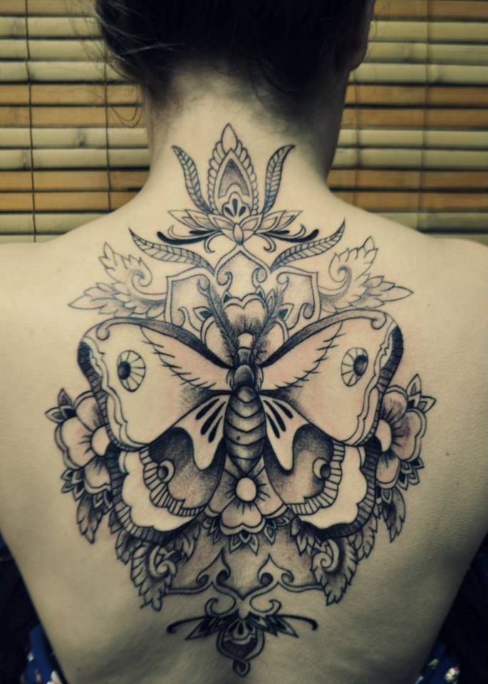 Black Ink Moth With Flowers Tattoo On Girl Upper Back