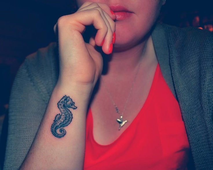 Black Ink Seahorse Tattoo On Girl Side Wrist