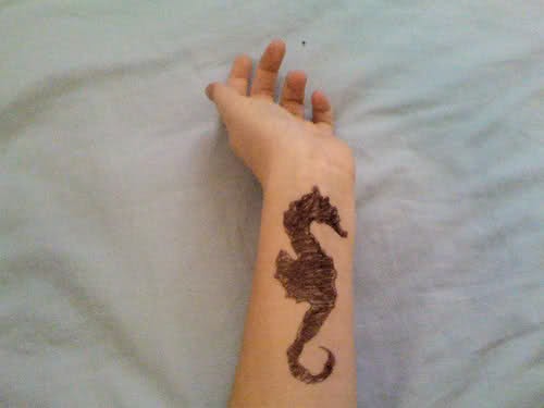 Black Ink Seahorse Tattoo On Wrist