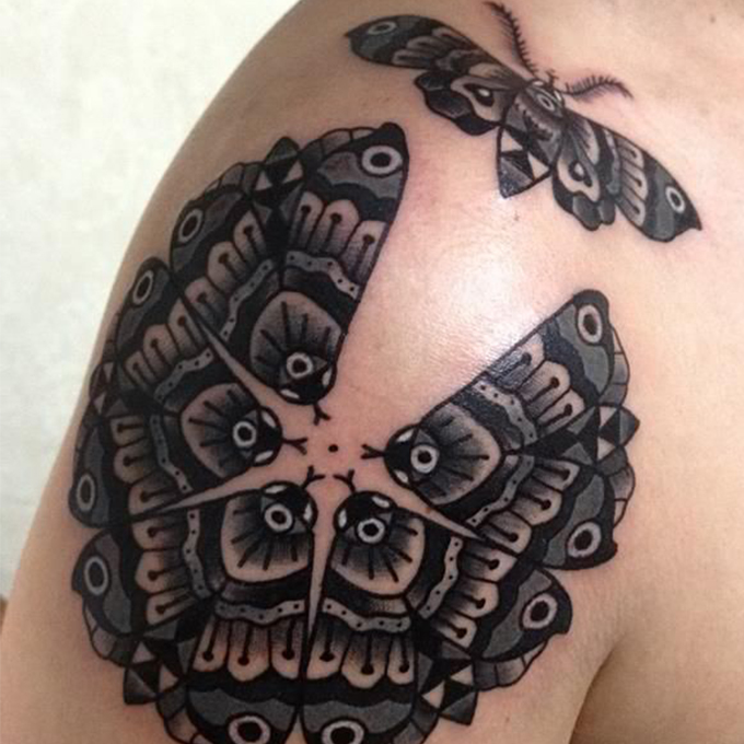Black Ink Six Moth Tattoo On Shoulder