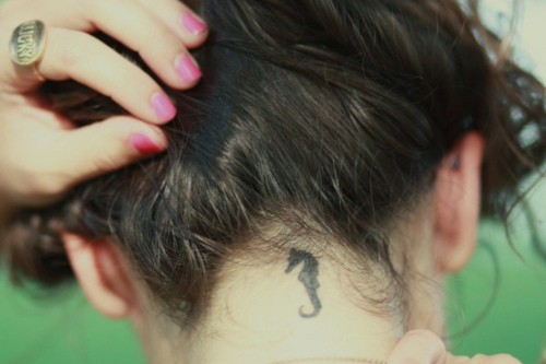Black Little Seahorse Tattoo On Girl Back Neck