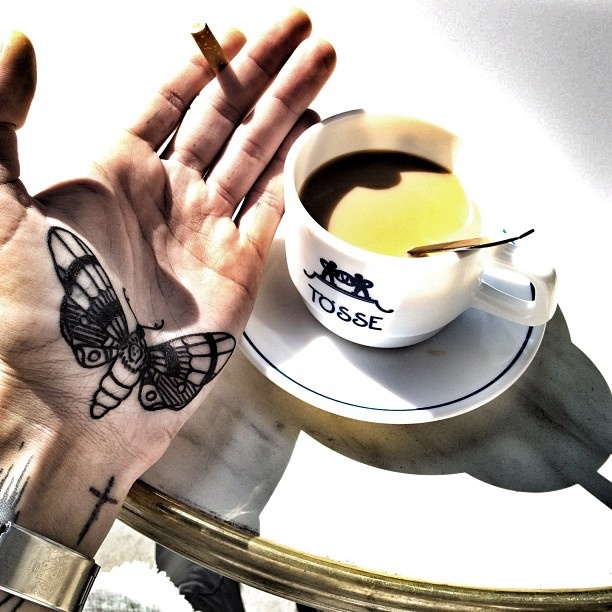 Black Moth Tattoo On Hand Palm