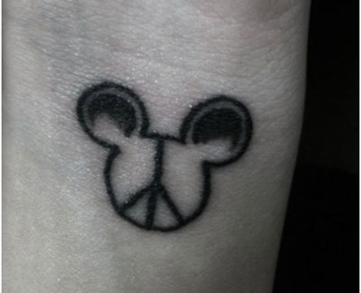 Black Peace Logo In Mickey Mouse Head Tattoo Design For Wrist