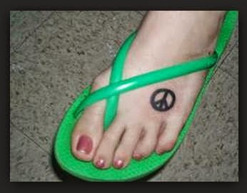Black Peace Logo Tattoo On Girl Foot