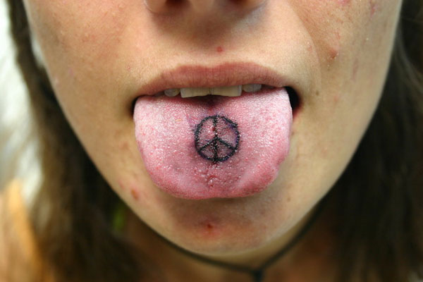 Black Peace Logo Tattoo On Girl Tongue