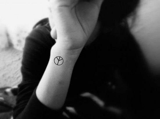 Black Peace Logo Tattoo On Side Wrist