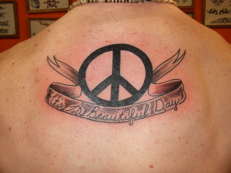 Black Peace Logo With Banner Tattoo On Upper Back
