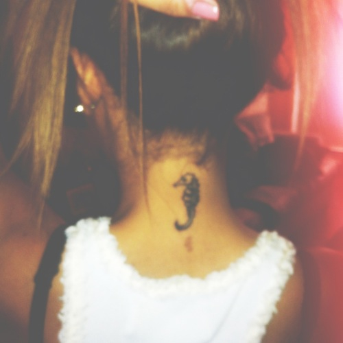 Black Seahorse Tattoo On Girl Back Neck