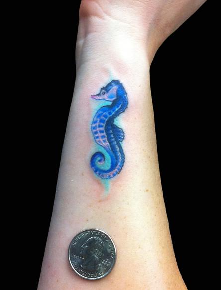 Blue Ink Seahorse Tattoo On Side Wrist