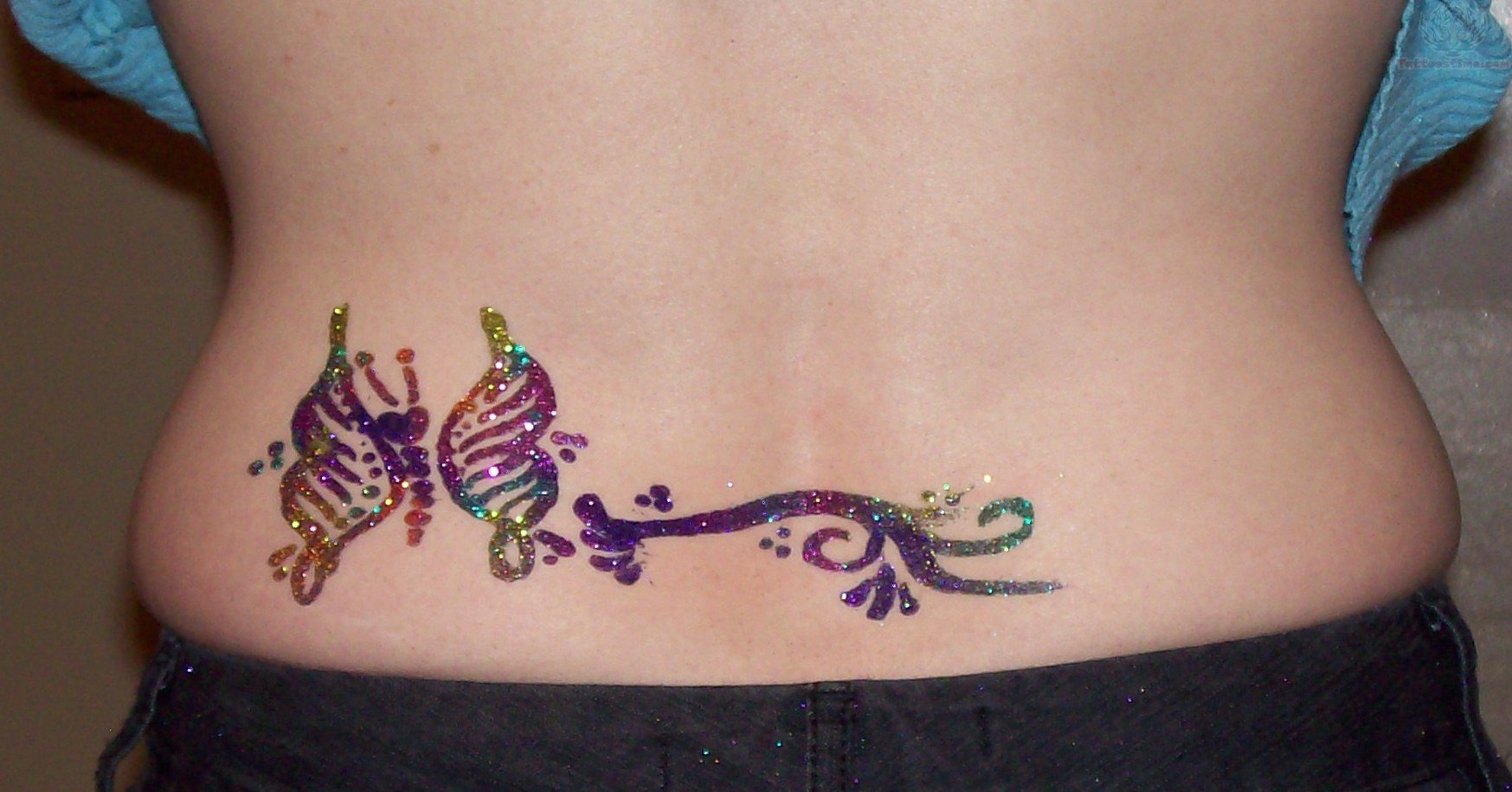 Colorful Glitter Butterfly Tattoo On Lower Back