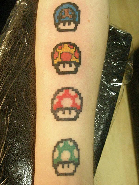 Colorful Mario Mushroom Tattoos On Forearm