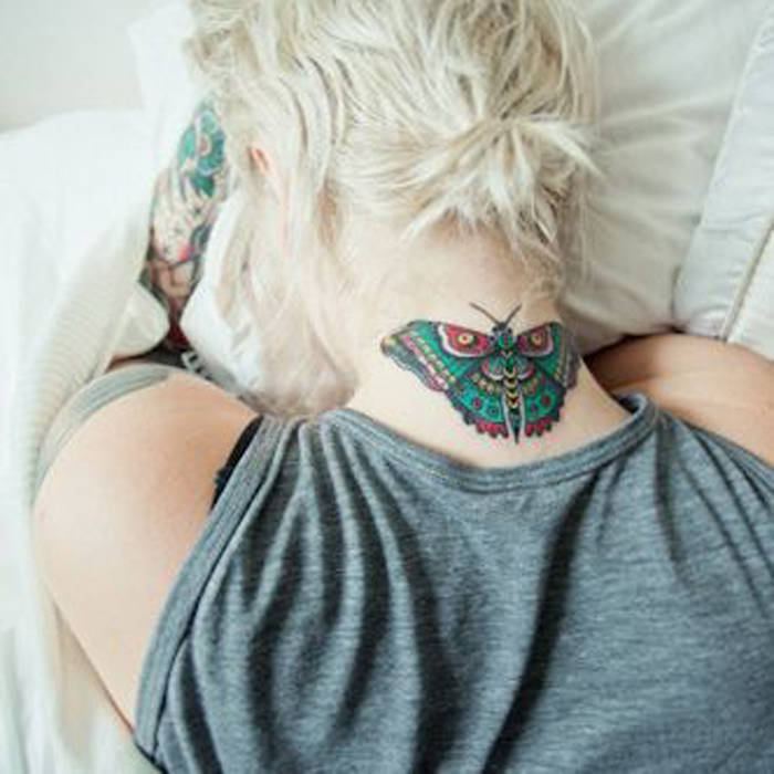 Colorful Moth Tattoo On Girl Upper Back