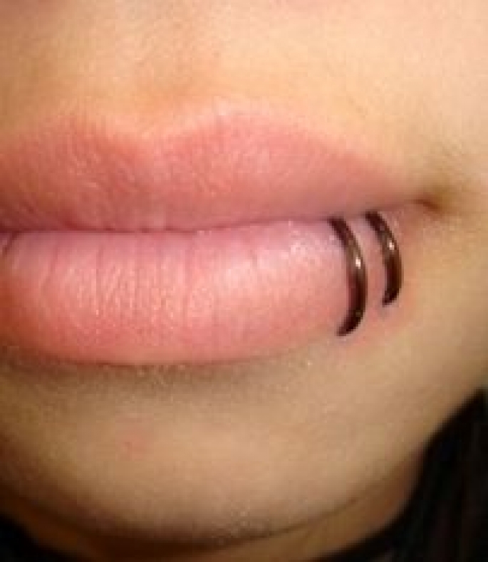 Double Lip Piercing With Black Rings