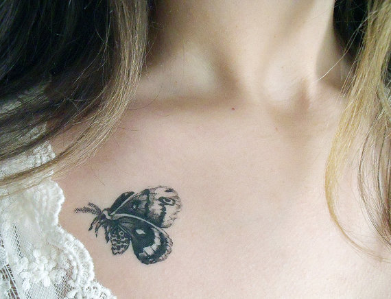 Girl Showing Realistic Moth Tattoo On Her Collarbone