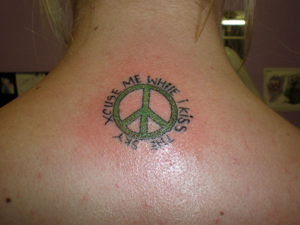 Green Ink Peace Symbol Tattoo On Upper Back