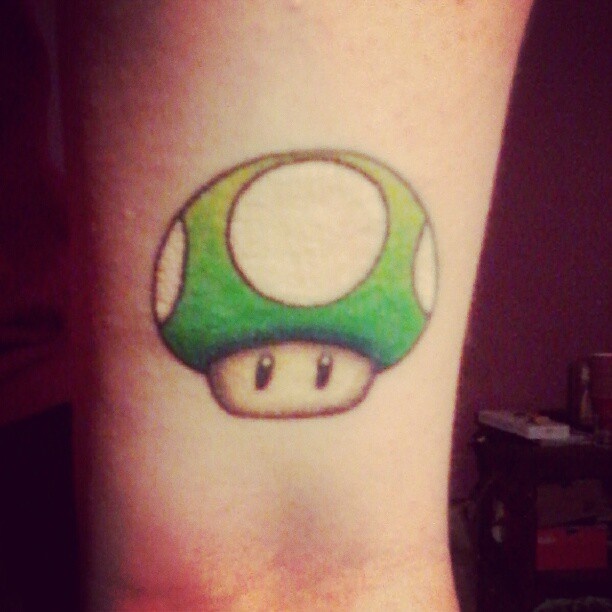 Green Mario Mushroom Tattoo On Arm