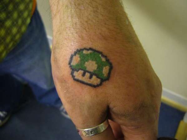 Green Mario Mushroom Tattoo On Left Hand