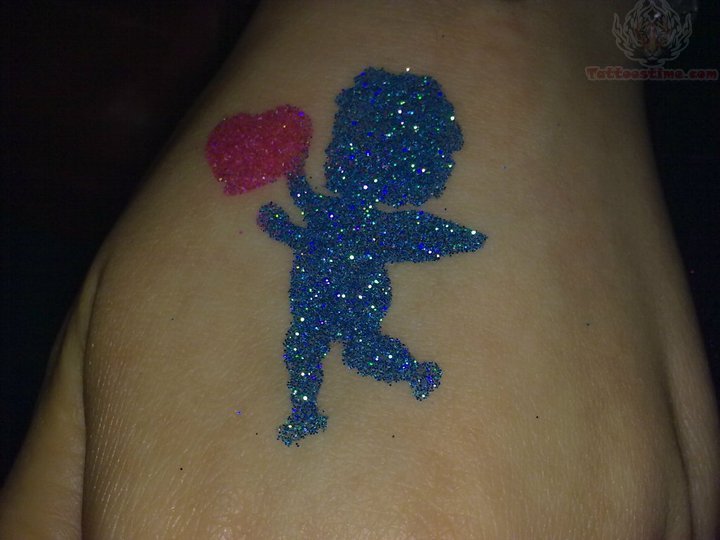 Inspiring Glitter Cherub With Heart Tattoo On Hand