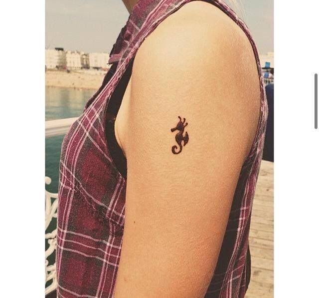 Little Silhouette Seahorse Tattoo On Left Shoulder