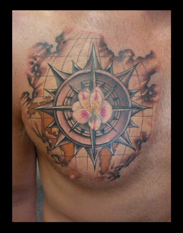Map With Compass And Flower Tattoo On Man Chest