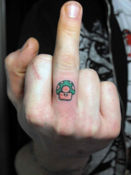 Mario Mushroom Tattoo On Middle Finger