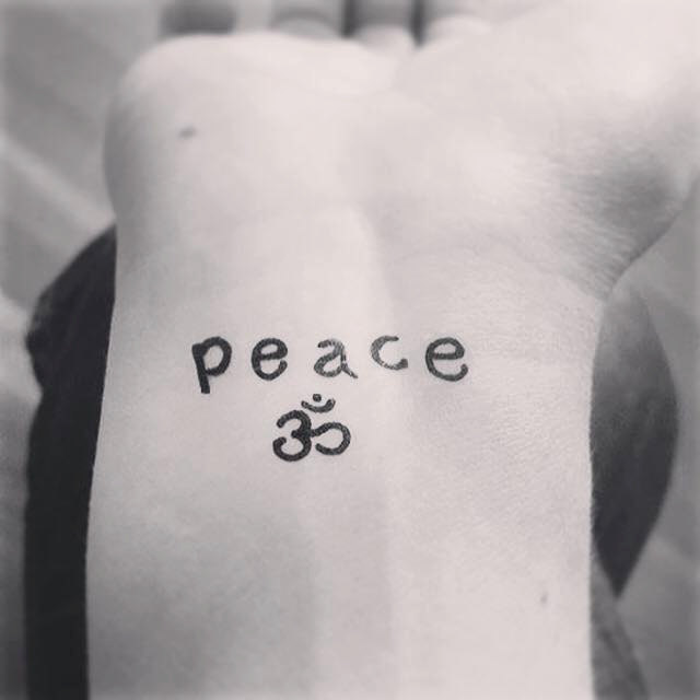 Peace Lettering With Om Tattoo On Wrist