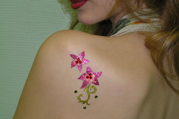 Pink And Green Glitter Two Flowers Tattoo On Girl Left Back Shoulder