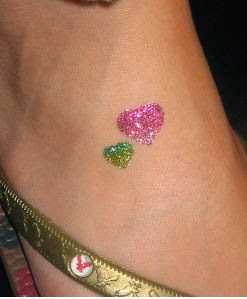 Pink And Green Glitter Two Heart Tattoo On Foot