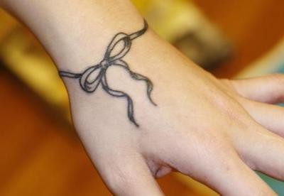Ribbon Bow Tattoo On Side Wrist