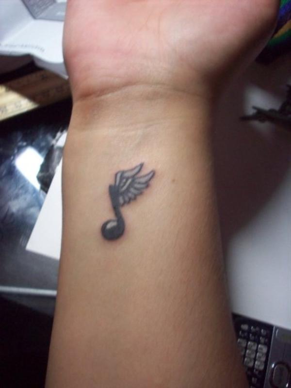 Winged Music Note Tattoo On Side Wrist