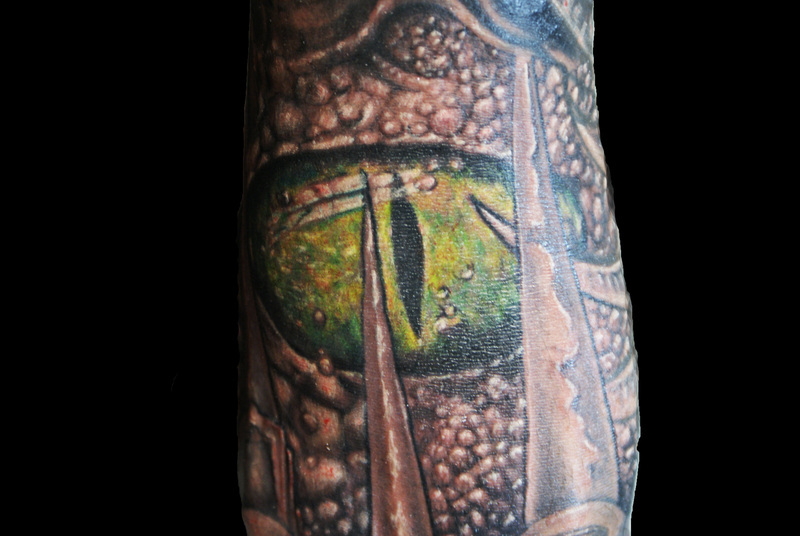 Amazing Alligator Eye Tattoo Design For Arm