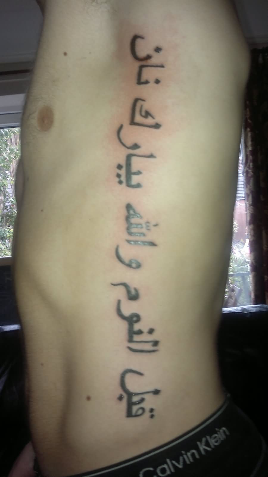 Arabic Tattoo On Side Rib