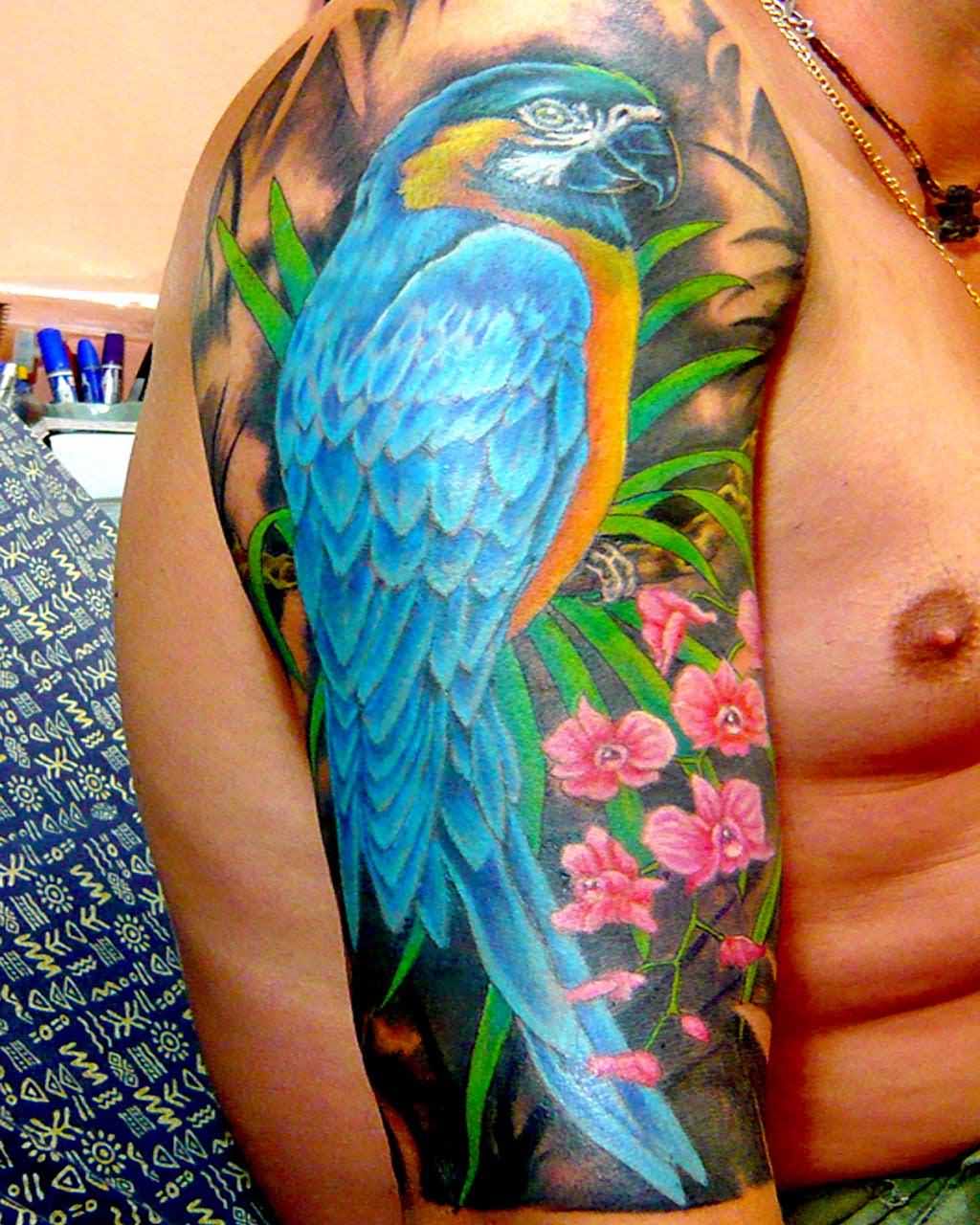 Attractive Parrot With Flowers Tattoo On Man Right Half Sleeve By Magic Tattoo Thailand