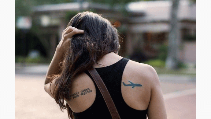 Black Airplane Tattoo On Girl Right Back Shoulder