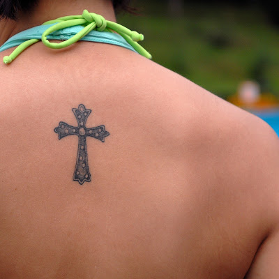 Black And Grey 3D Little Cross Tattoo On Upper Back