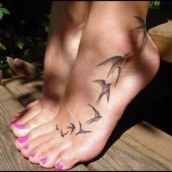Black And Grey Flying Birds Tattoo On Girl Foot