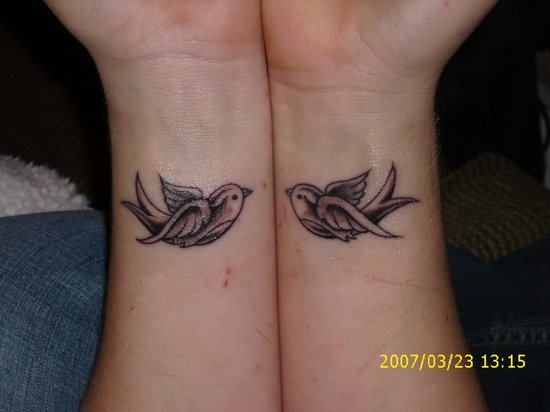 Black And Grey Flying Birds Tattoos On Wrist