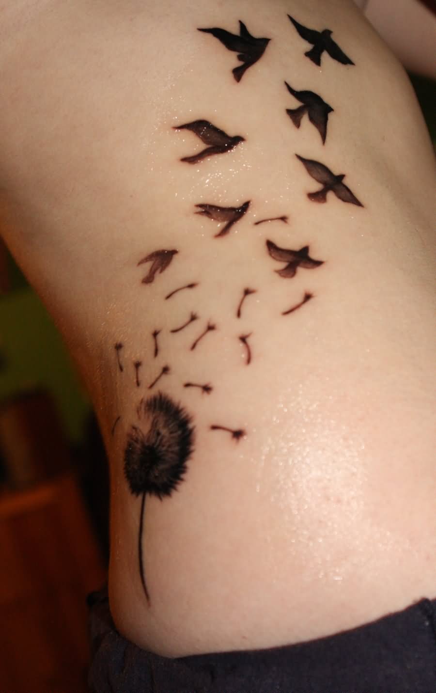 Black Dandelion With Flying Birds Tattoo On Side Rib By Alisha